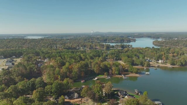 High drone footage of the houses and green trees on the shores of Lake Norman in Troutman, NC, USA