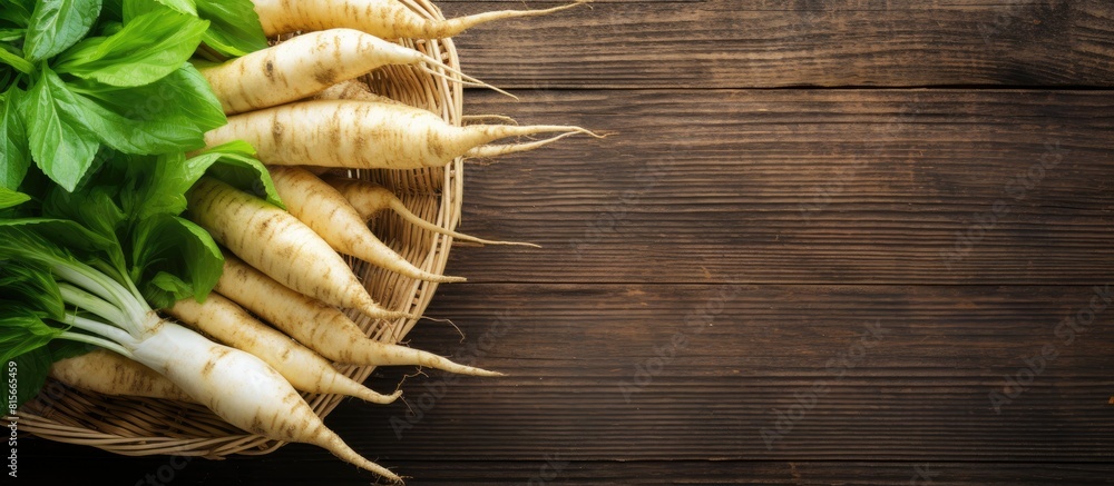 Poster fresh ripe parsnips in wicker basket on wooden table top view space for text. copy space available