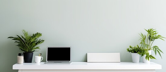 Flat lay composition with copy space of white desk table on home office Notebook blank sheets of paper pen and computer keyboard and a green plant as decoration