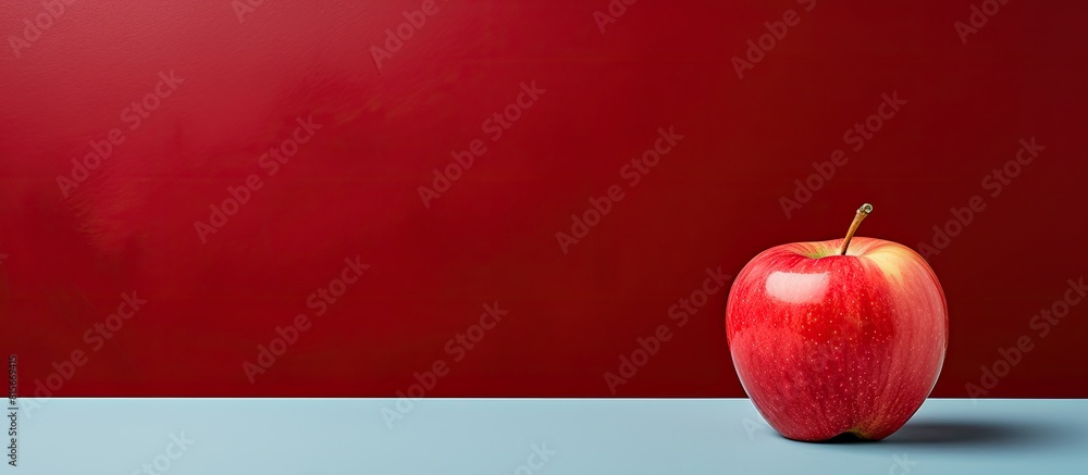 Aufkleber A red apple is placed on a background of the same color creating a cohesive concept and providing ample copy space
