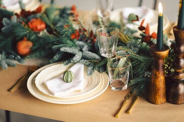 Festive and elegant Christmas dinner setting with ornate golden-plated silverware