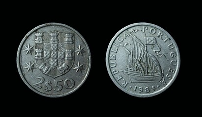 Closeup of Portugese Escudo coins on a black background