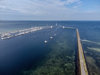 A collection of small boats arranged in a picturesque harbor : Sweden, Ales stenar