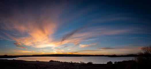 sunset in lake and clouds are reflected in the water,