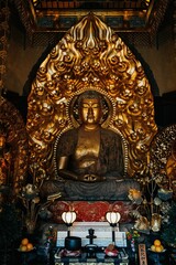 Golden Japanese Buddha Statue at a shrine in Kamakura, Japan