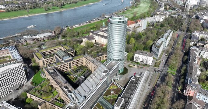 Aerial drone view large insurance company office headquarters in Dusseldorf, Germany along the rhine river and urban city overview.