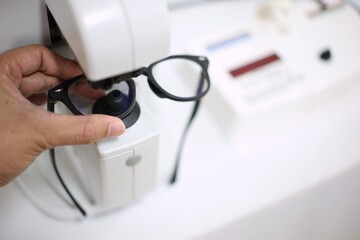 Hand holding glasses in eyeglasses store