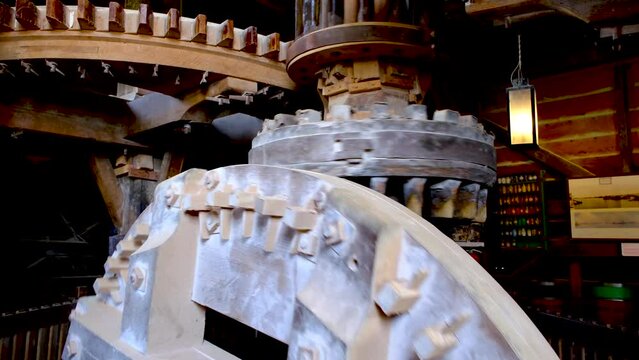 Moving parts inside a traditional Dutch windmill.