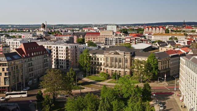 Aerial view over Dresden Music university carl Maria von weber. Cars drive at streets and yellow tram drives through the picture. Drone Move forward