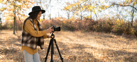 beautiful Caucasian woman doing a photo shoot in the autumn forest. A professional photographer...