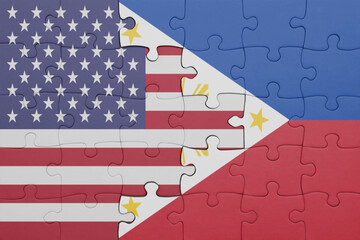puzzle with the colourful national flag of philippines and flag of united states of america .