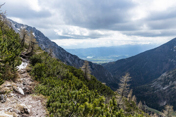 Begunj&scaron;čica panorama of mountain trekking to the highest peak. View of the Alps, climbing with via ferrata. Distant view of Lake Bled from above. Sports holidays, life of adventure in the countryside