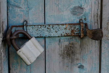 one old padlock on old door	