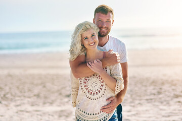 Portrait, couple and hug on beach with love for seaside romance, serene seascape and ocean view...
