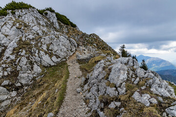 Begunjščica panorama of mountain trekking to the highest peak. View of the Alps, climbing with via ferrata. Distant view of Lake Bled from above. Sports holidays, life of adventure in the countryside