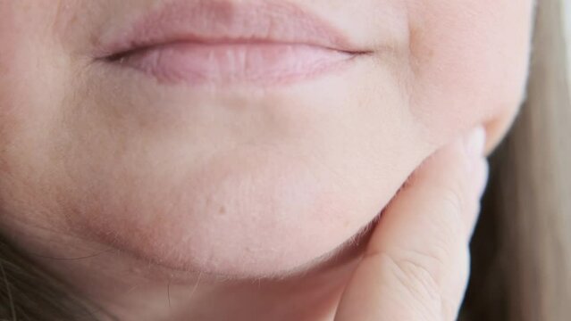 close-up Female face with Jowls, double chin, Skin sagging, Volume reduction, mature woman 50 years old, wrinkles skin, aging natural process, aesthetic injection cosmetology, anti-aging procedures