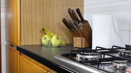 In the kitchen knife block with kitchenette and fruit