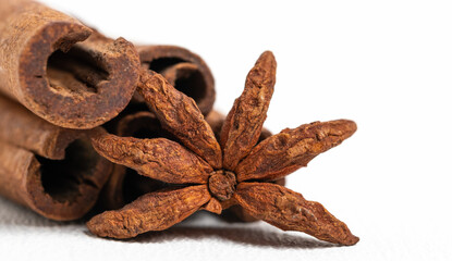 Cinnamon sticks and star anise on a white background.