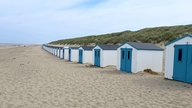 Texel Little white blue houses in the dunes in Holland on the island of Texel in the Netherlands, De Koog beach with sand dunes