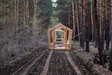 Wooden gazebo in the middle of the forest.