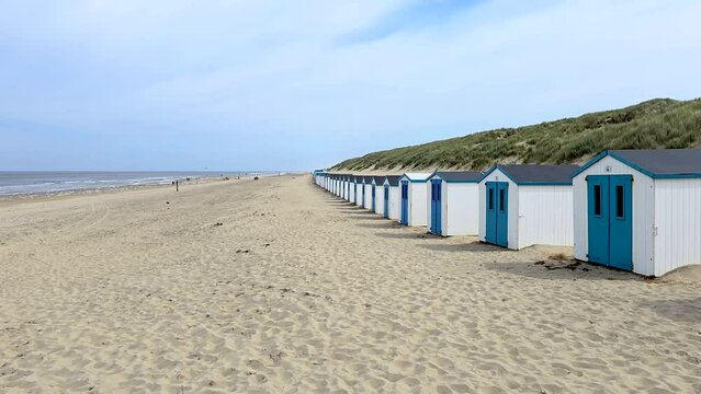 Texel Little white blue houses in the dunes in Holland on the island of Texel in the Netherlands, De Koog beach with sand dunes during summer