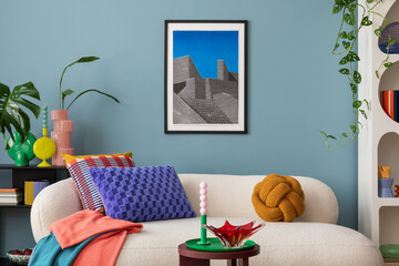 Modern and colorful interior of living room with design boucle sofa, mock up poster, shelf, plants,...