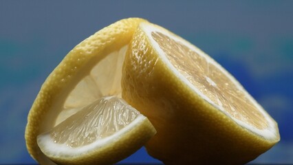 A slice of fresh lemon, bright yellow and vibrantly citric, lies exposed. The flesh, glistening...
