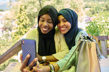 Middle Eastern Muslim Women Capturing Selfies in Serene Surroundings
