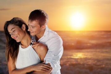 Lovely couple have fun together at the beach