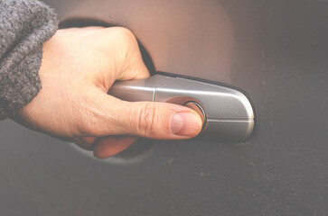 Man's hand on the handle of a car close-up