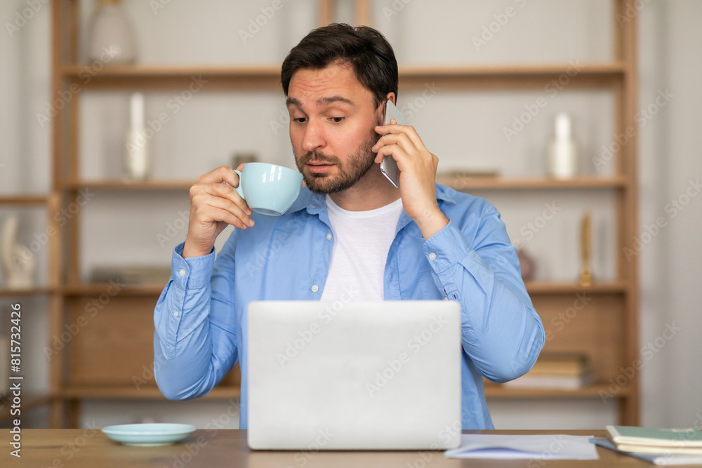 Poster a man is standing with a cup of coffee in hand, engaged in a conversation on his phone. he appears f
