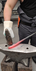Blacksmith Hammering Hot Metal on Anvil