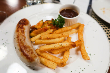 sausage and fries with sauce. A Switzerland style dish