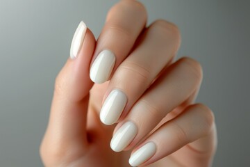 Close-up of a woman's hand with an elegant neutral manicure. Beautiful light pink gel nail polish on rectangular nails