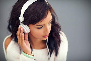 Girl, listening and streaming music with headphones and app for easy download of audio or podcast....