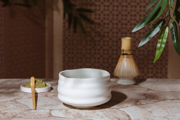 Tea ceremony from the matcha. Tyawan, tyasaku, tyasen on a stone table top among bamboo leaves with copy space