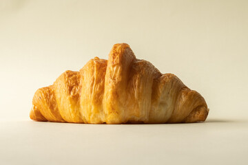freshly baked croissants in a colored background, green, black, or neutral. with fresh flowers newspaper, cappuccino showing layers and crumbles and filling with berries