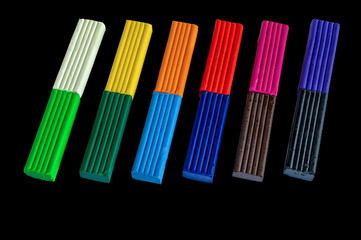 Pieces of colored plasticine on a dark background