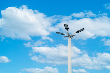 LED street lamp post, Ambient lighting pole with bright blue sky cloud daylight background.