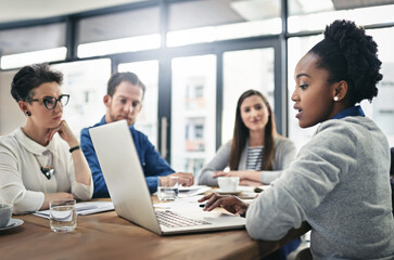 Company, discussion and business people with laptop in office for strategy, meeting and brainstorming. Employees, collaboration and review with paperwork for financial investment, report and planning