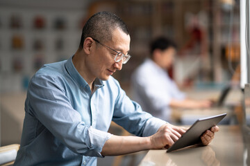 businessman using tablet in library