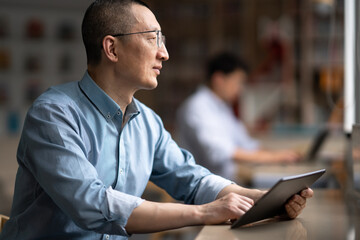 businessman using tablet in library