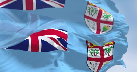 National flags of FIji waving in the wind on a clear day