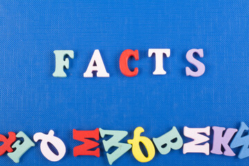 FACTS word on blue background composed from colorful abc alphabet block wooden letters, copy space...