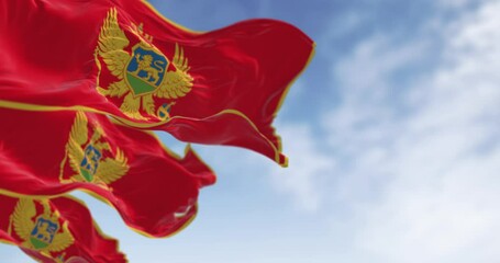 National flags of Montenegro waving in the wind on a clear day - Powered by Adobe