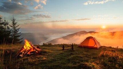 a camping on the hill. bonfire. fog. a morning sunrise