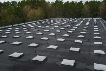 Top view of a modern roof with natural light. Skylights. Energy efficiency. Transparent panels on the roof. © Natalia Prasm
