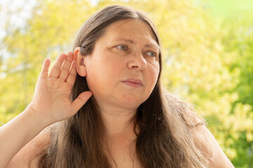 caucasian mature woman difficulty hearing, cerumen impaction, hearing loss, medical concept, loud...