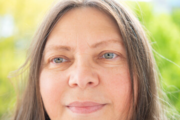 Caucasian positive 50-year-old attractive woman looking at camera, pretty face close up portrait,...