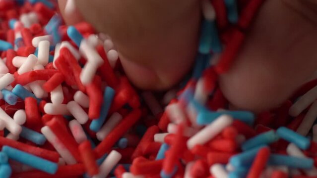 Macro video of colourful confetti kept on rotating disk.